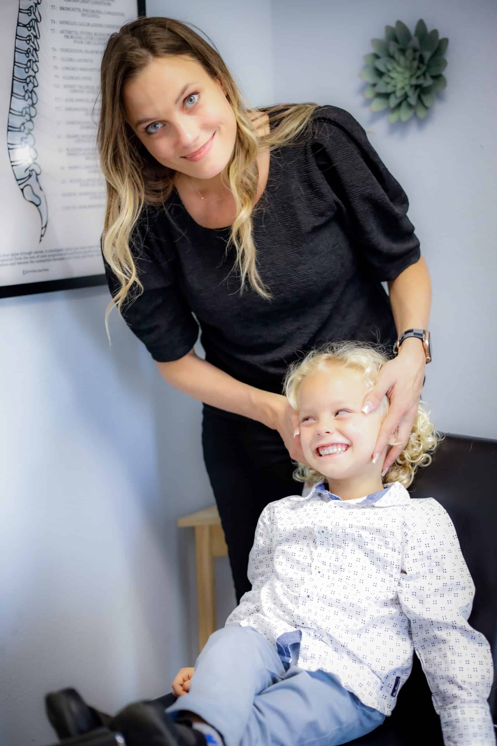 Dr. Amy Kerr adjusting patient in treatment chair at chiropractic clinic