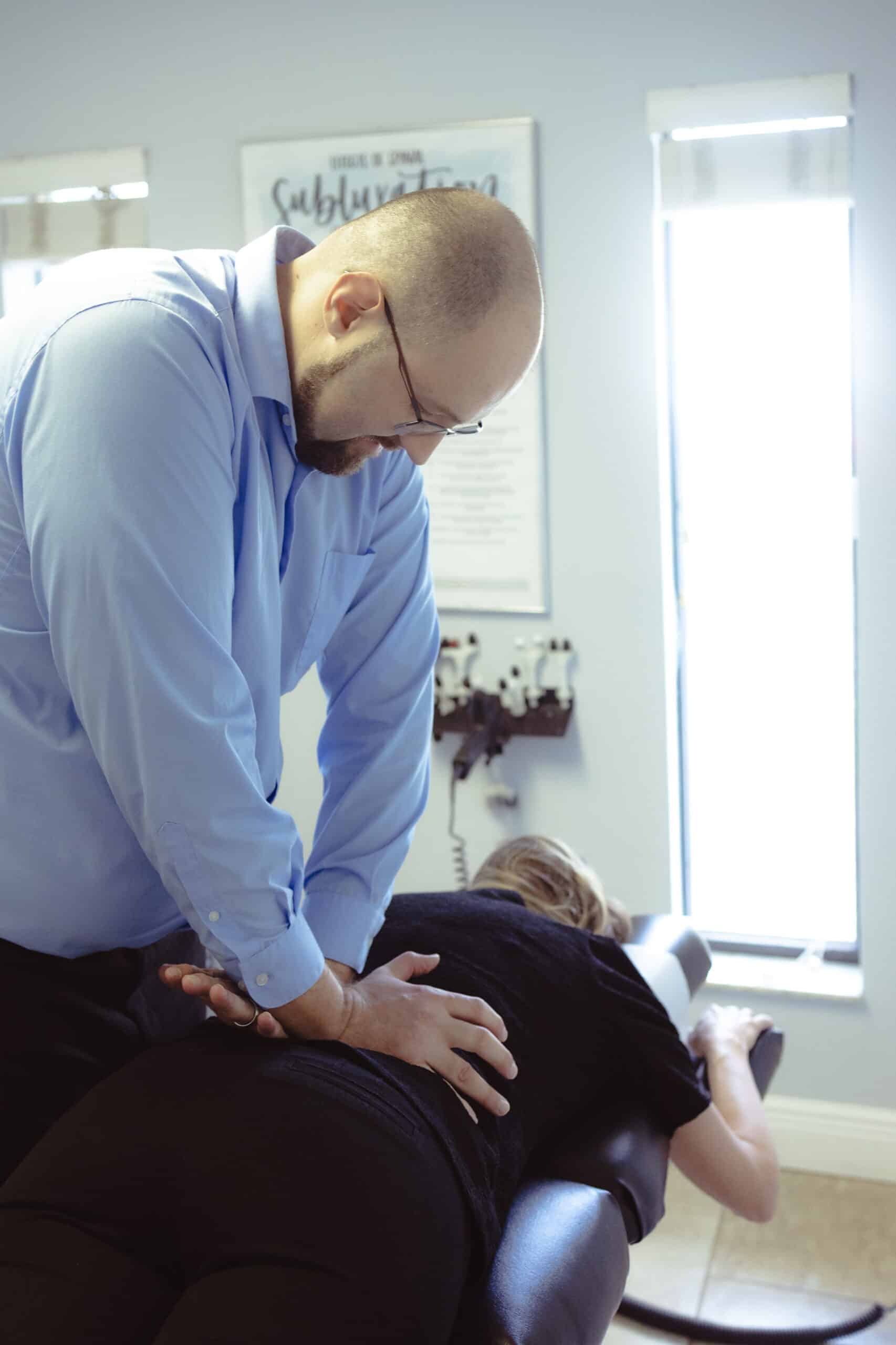 Chiropractor Dr. Kyle adjusting spine at Grace Medical & Chiropractic