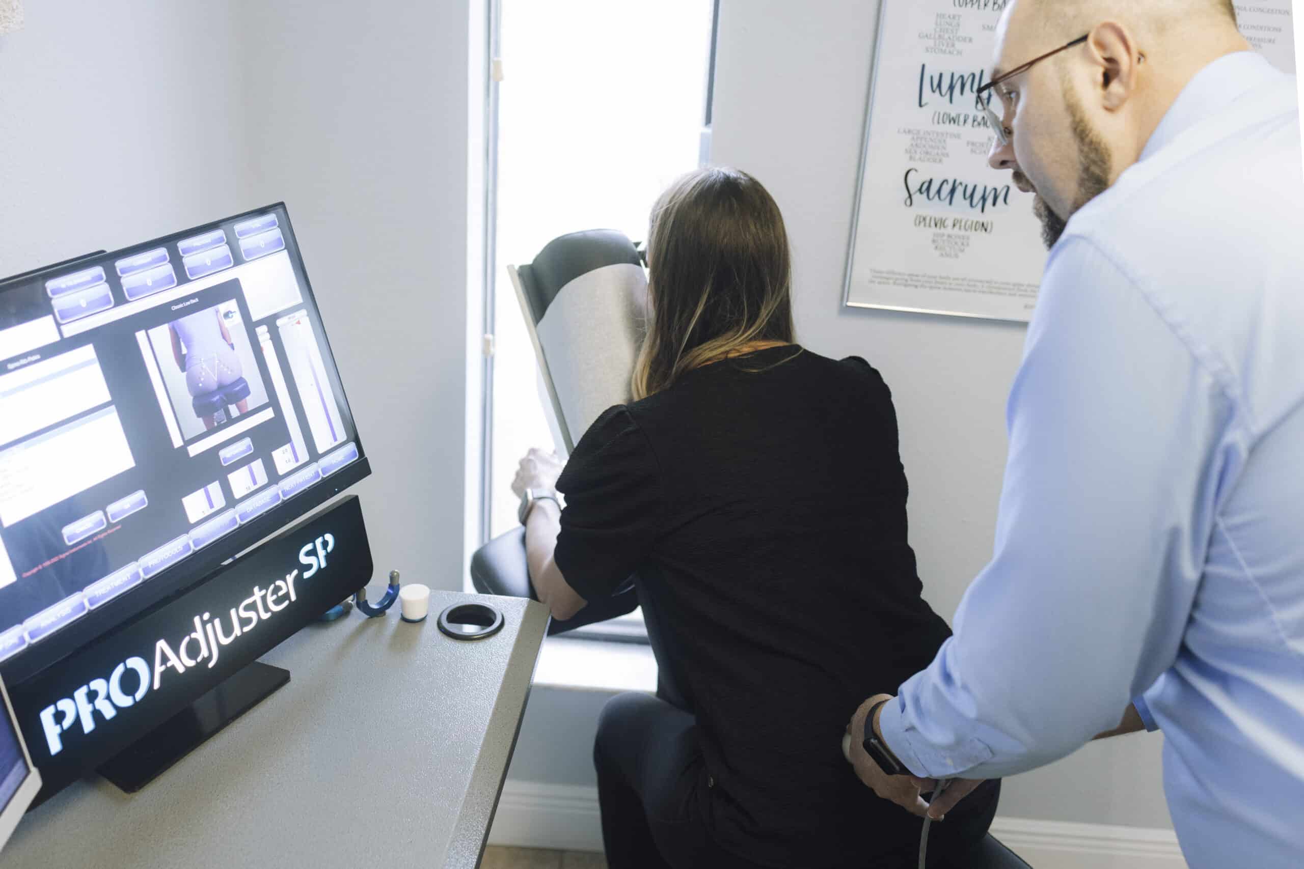 ProAdjuster instrument lower back treatment at Grace Medical chiropractic clinic